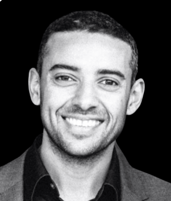Portrait of a young man in formal attire with dramatic lighting and shadows, captured in an octagonal frame, conveying a thoughtful expression.